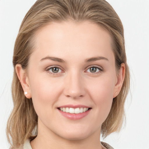 Joyful white young-adult female with medium  brown hair and grey eyes