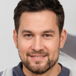 Joyful white adult male with short  brown hair and brown eyes