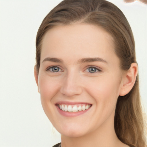 Joyful white young-adult female with long  brown hair and grey eyes