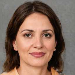 Joyful white adult female with medium  brown hair and brown eyes