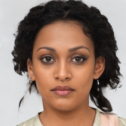 Neutral black young-adult female with medium  brown hair and brown eyes