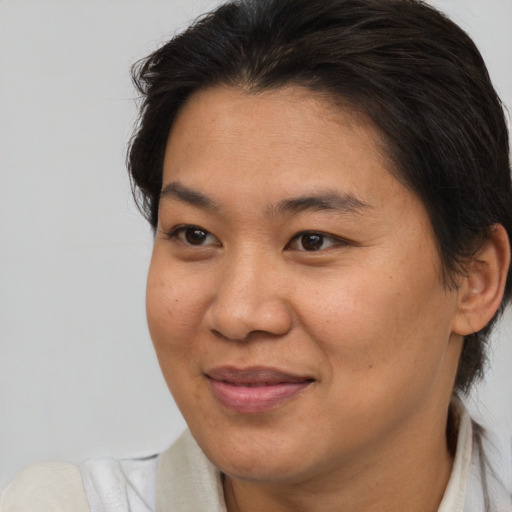 Joyful asian young-adult female with medium  brown hair and brown eyes