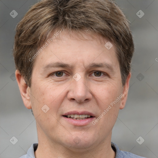 Joyful white adult male with short  brown hair and grey eyes