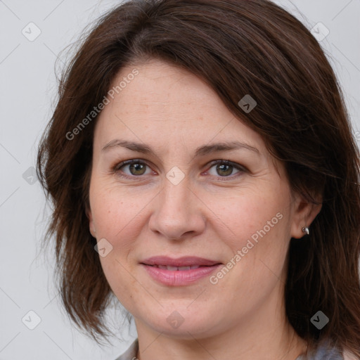 Joyful white adult female with medium  brown hair and grey eyes