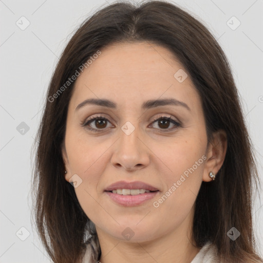 Joyful white adult female with long  brown hair and brown eyes