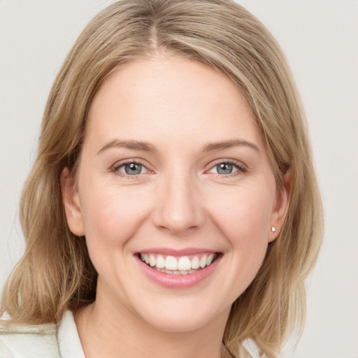 Joyful white young-adult female with medium  brown hair and blue eyes