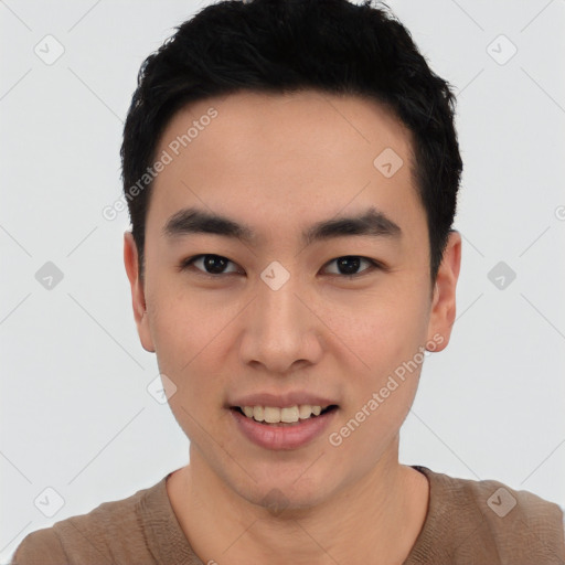 Joyful asian young-adult male with short  black hair and brown eyes