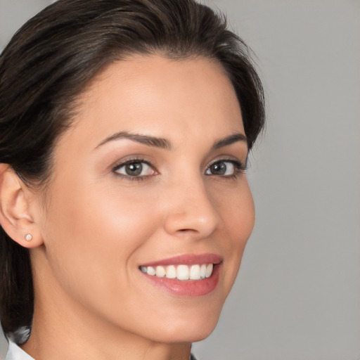 Joyful white young-adult female with medium  brown hair and brown eyes