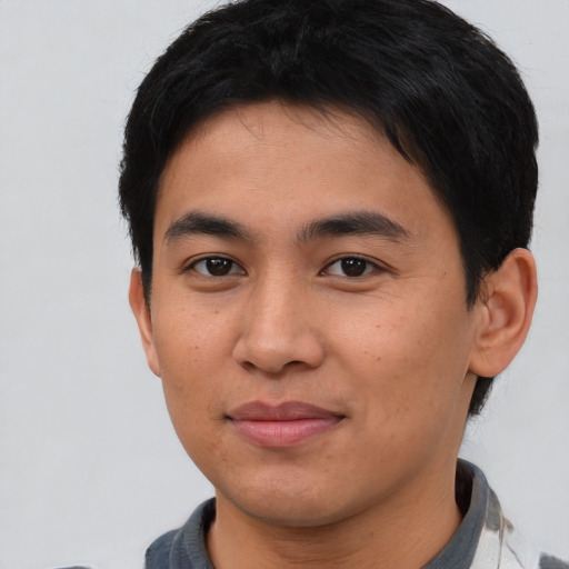 Joyful asian young-adult male with short  brown hair and brown eyes