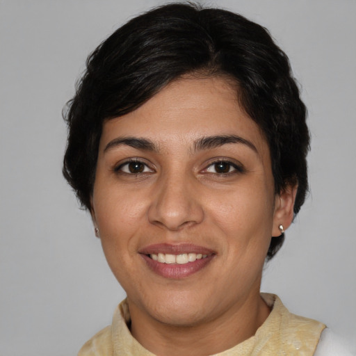 Joyful white young-adult female with short  brown hair and brown eyes