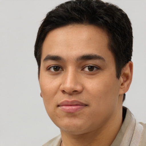Joyful latino young-adult male with short  brown hair and brown eyes