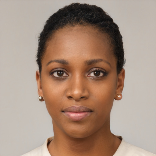 Joyful black young-adult female with short  black hair and brown eyes