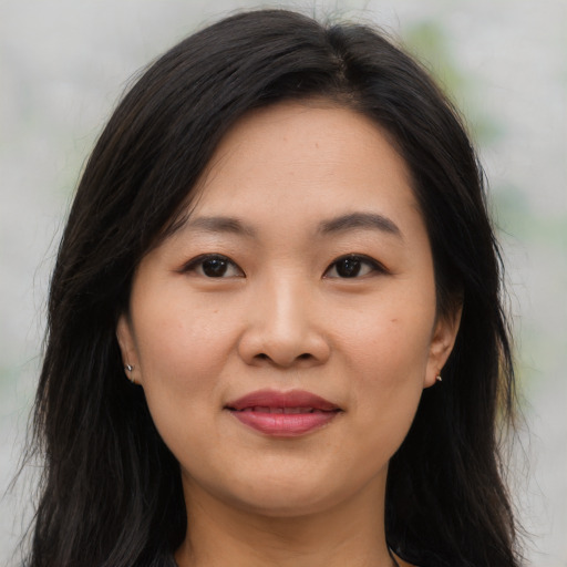 Joyful asian young-adult female with long  brown hair and brown eyes