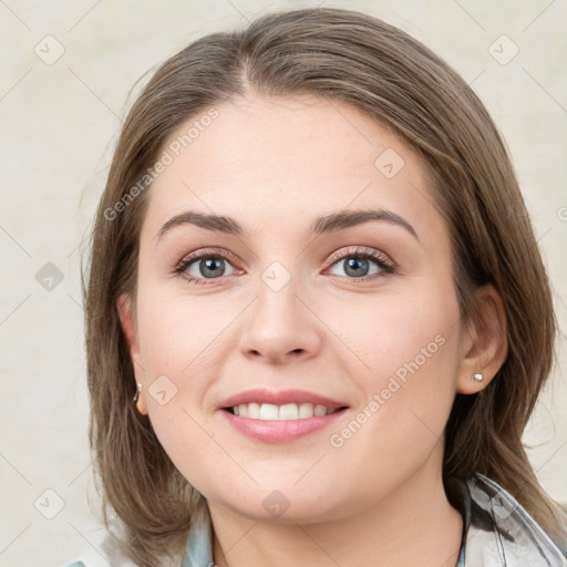 Joyful white young-adult female with medium  brown hair and green eyes