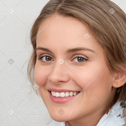 Joyful white young-adult female with medium  brown hair and green eyes