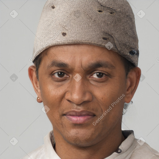 Joyful latino adult male with short  brown hair and brown eyes