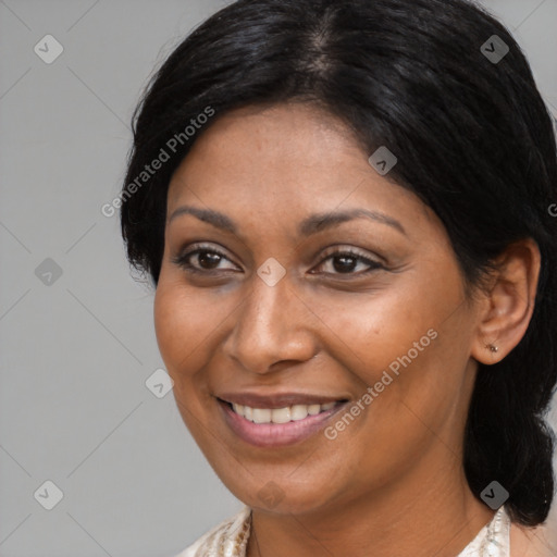 Joyful black adult female with medium  black hair and brown eyes