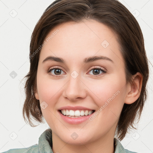 Joyful white young-adult female with medium  brown hair and green eyes