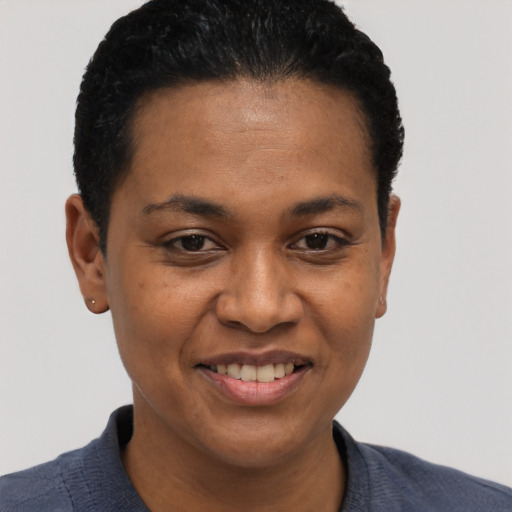 Joyful black young-adult female with short  black hair and brown eyes
