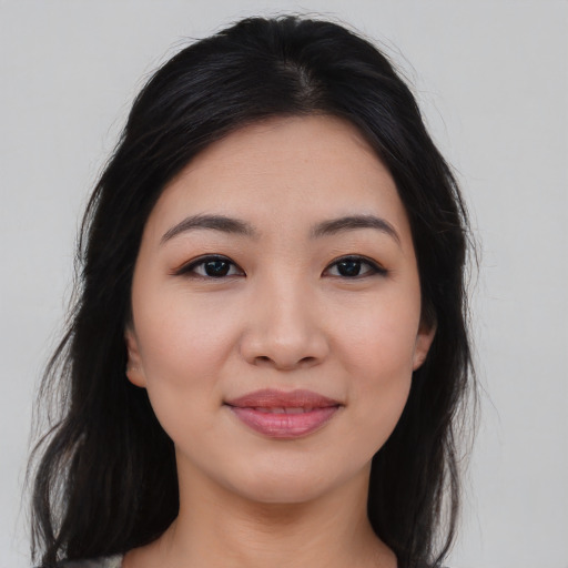 Joyful asian young-adult female with long  brown hair and brown eyes