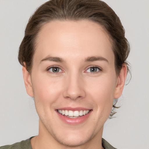 Joyful white young-adult female with short  brown hair and grey eyes