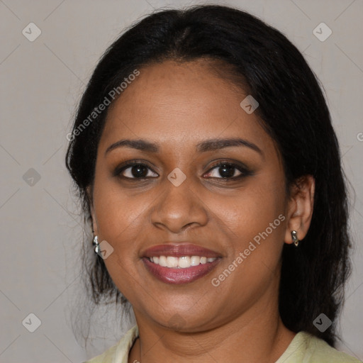 Joyful black young-adult female with long  black hair and brown eyes