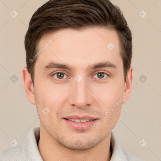 Joyful white young-adult male with short  brown hair and grey eyes