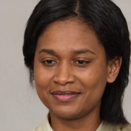 Joyful latino adult female with medium  brown hair and brown eyes