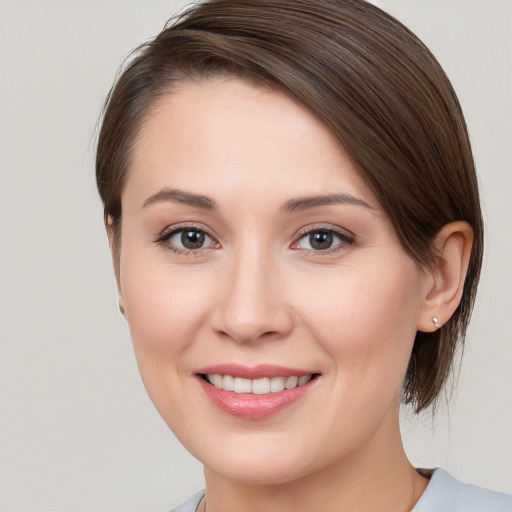 Joyful white young-adult female with medium  brown hair and brown eyes