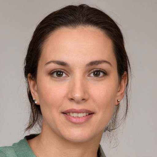 Joyful white young-adult female with medium  brown hair and brown eyes