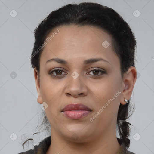 Joyful black young-adult female with long  brown hair and brown eyes