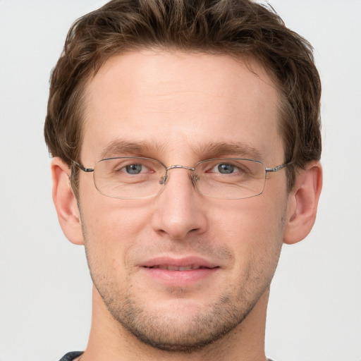 Joyful white adult male with short  brown hair and grey eyes