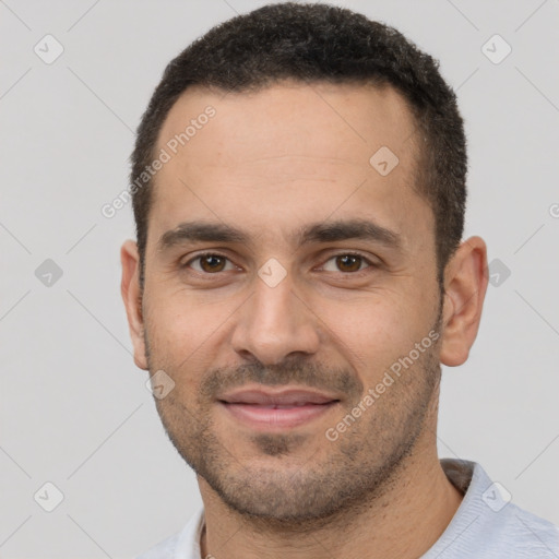 Joyful white young-adult male with short  black hair and brown eyes