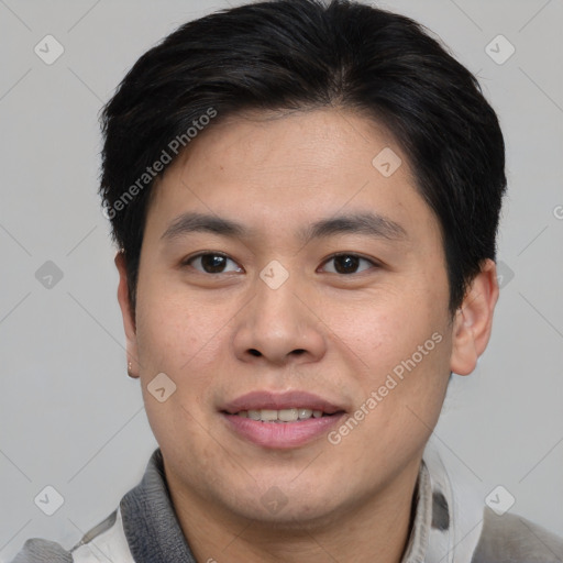 Joyful asian young-adult male with short  brown hair and brown eyes