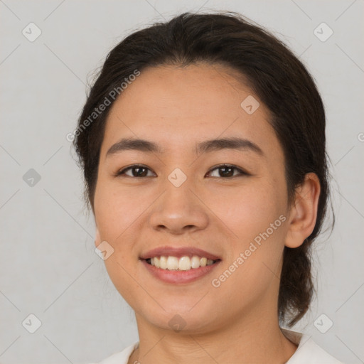 Joyful latino young-adult female with medium  brown hair and brown eyes