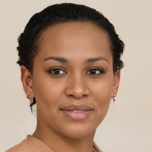 Joyful black young-adult female with short  brown hair and brown eyes