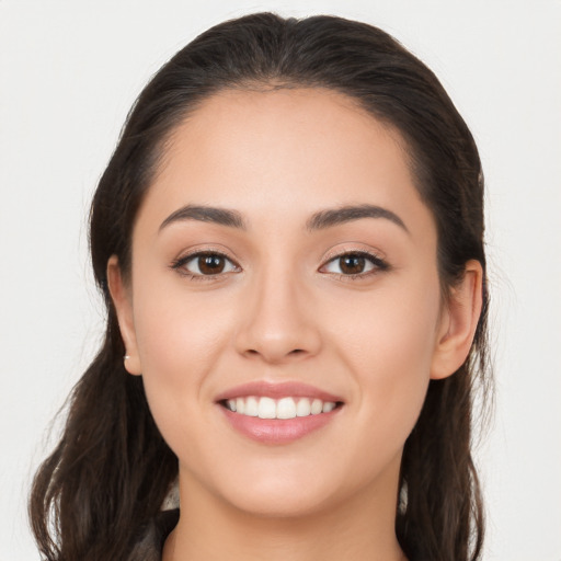 Joyful white young-adult female with long  brown hair and brown eyes