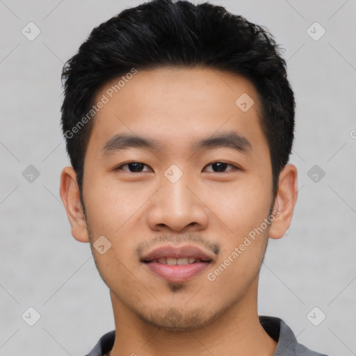 Joyful asian young-adult male with short  black hair and brown eyes