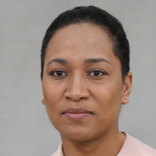 Joyful latino adult female with short  black hair and brown eyes