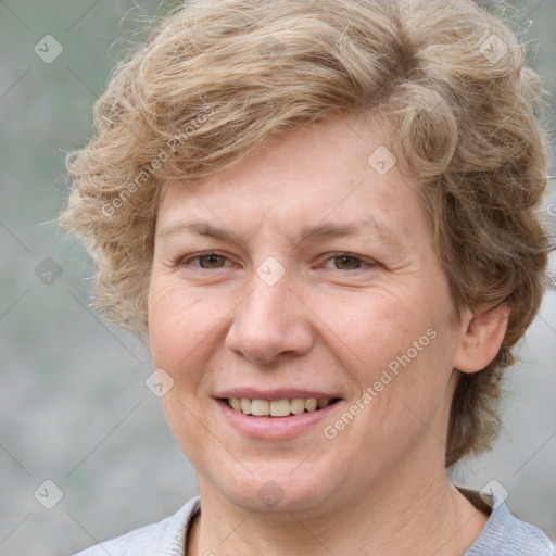 Joyful white adult female with medium  brown hair and blue eyes