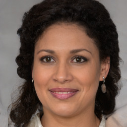 Joyful black adult female with medium  brown hair and brown eyes