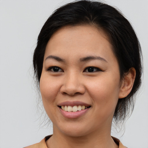 Joyful asian young-adult female with medium  brown hair and brown eyes