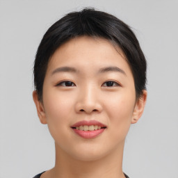 Joyful asian young-adult female with short  black hair and brown eyes