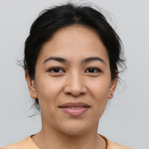 Joyful asian young-adult female with medium  brown hair and brown eyes