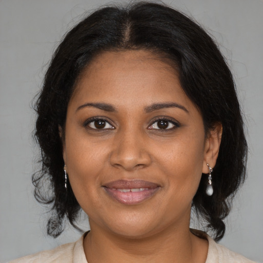 Joyful black young-adult female with medium  brown hair and brown eyes