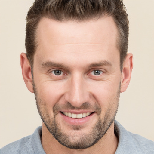 Joyful white adult male with short  brown hair and brown eyes