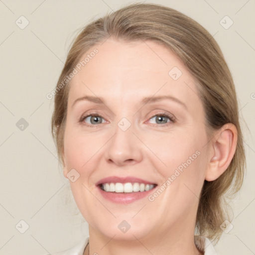 Joyful white adult female with medium  brown hair and blue eyes