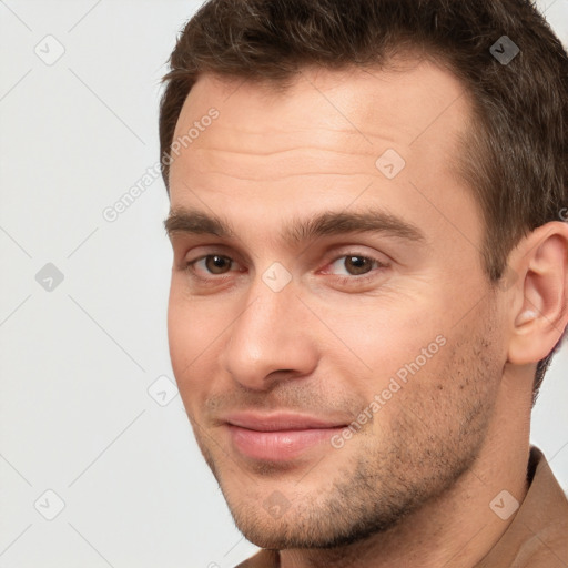 Joyful white young-adult male with short  brown hair and brown eyes