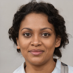 Joyful black adult female with medium  brown hair and brown eyes