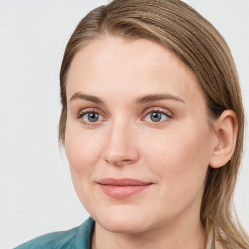 Joyful white young-adult female with medium  brown hair and blue eyes